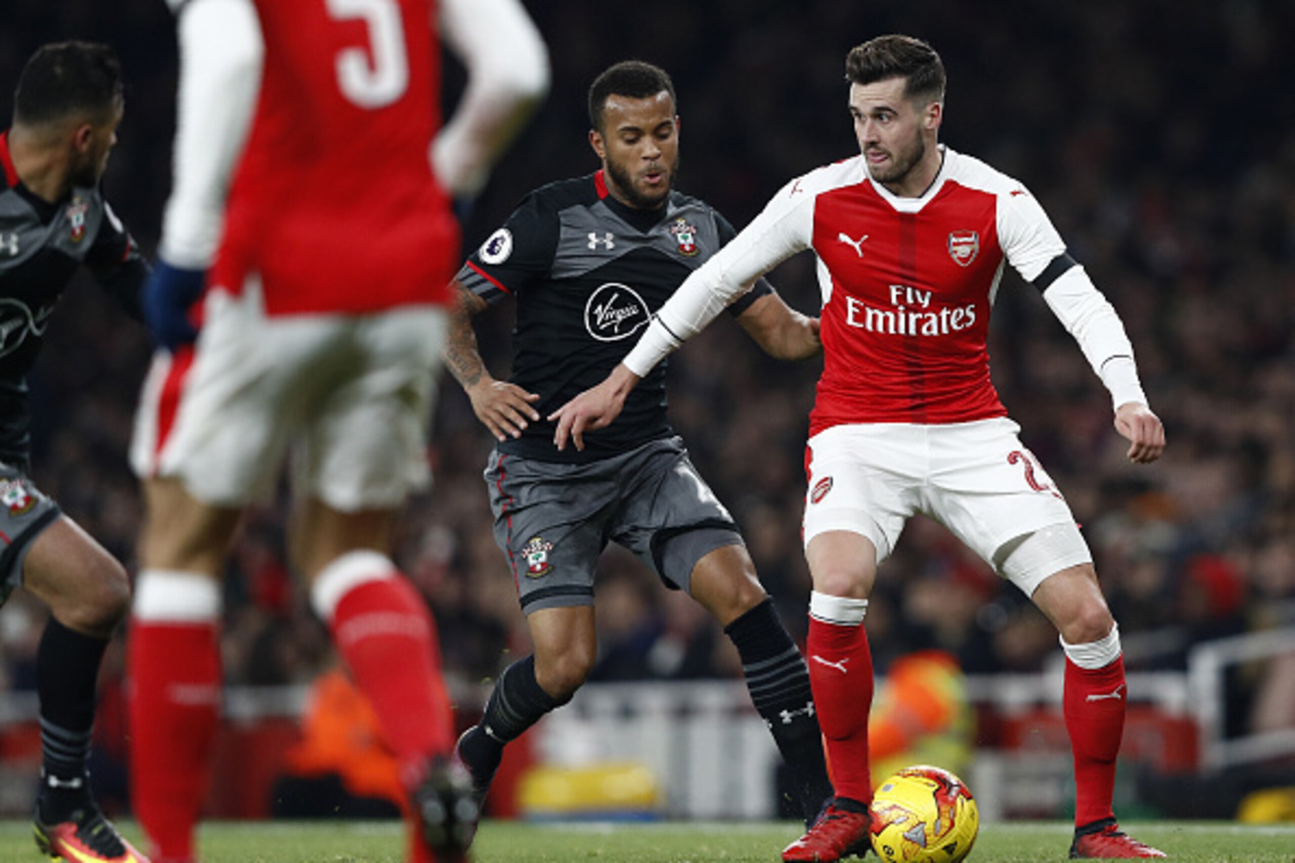 Southampton's English defender Ryan Bertrand (C) vies with Arsenal's English defender Carl Jenkinson during the EFL (English Football League) Cup quarter-final football match between Arsenal and Southampton at the Emirates Stadium in London on November 30