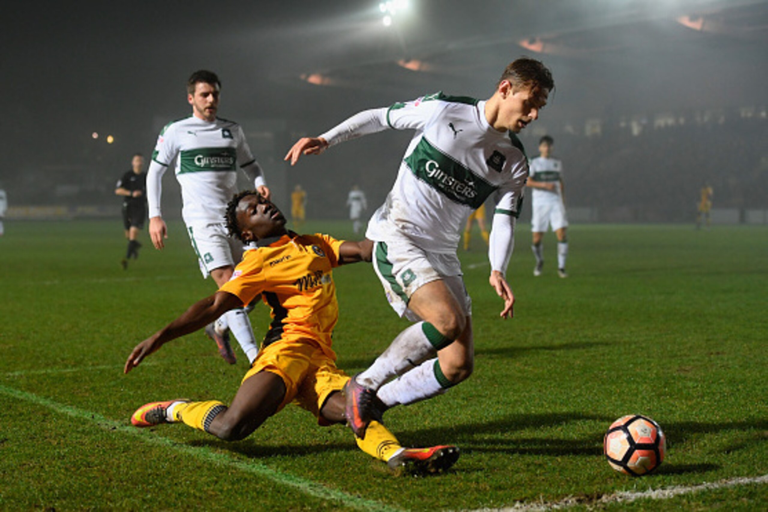 NEWPORT, WALES - DECEMBER 21:  Newport player Jordan Green is warded off the ball by Oscar Threlkeld of Plymouth during The Emirates FA Cup Second Round Replay between Newport County and Plymouth Argyle at Rodney Parade on December 21, 2016 in Newport, Wa