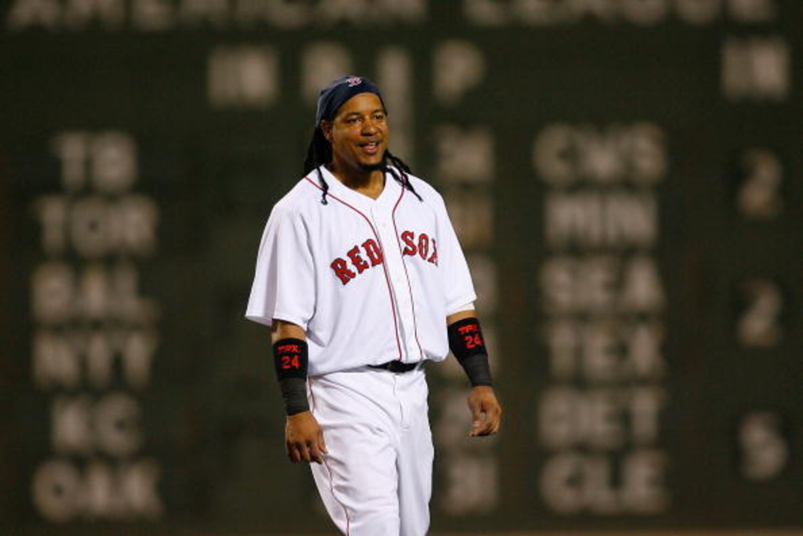 BOSTON - JULY 30: Manny Ramirez #24 of the Boston Red Sox waits for his glove to be brought to him by a teammate during action against  the Los Angeles Angels of Anaheim at Fenway Park on July 30, 2008 in Boston, Massachusetts.  (Photo by Jim Rogash/Getty