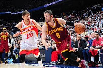 ATLANTA, GA - MARCH 6: Kevin Love #0 of the Cleveland Cavaliers drives against Kyle Korver #26 of the Atlanta Hawks on March 6, 2015 at Philips Arena in Atlanta, Georgia.  NOTE TO USER: User expressly acknowledges and agrees that, by downloading and/or us