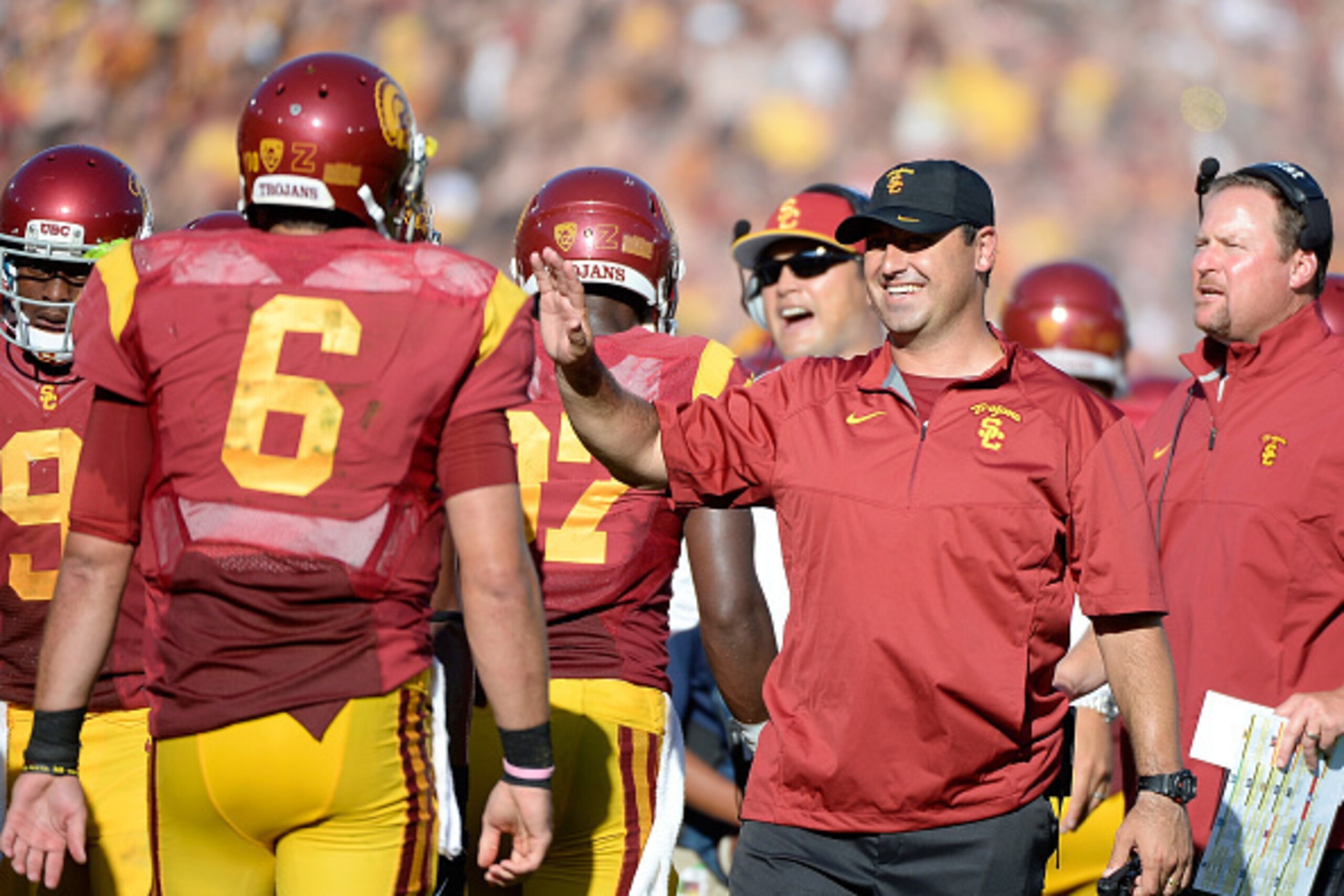 LOS ANGELES, CA - AUGUST 30:  Steve Sarkisian celebrates the touchdown of wide receiver Nelson Agholor #15 with quarterback Cody Kessler #6 to take a 21-0 lead over the Fresno State Bulldogs during the first quarter at Los Angeles Memorial Coliseum on Aug
