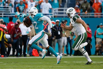 MIAMI GARDENS, FL - NOVEMBER 6: Kenyan Drake #32 of the Miami Dolphins is pursued by Nick Folk #2 of the New York Jets as he runs 96 yards for a touchdown on November 6, 2016 at Hard Rock Stadium in Miami Gardens, Florida. The Dolphins defeated the Jets 2