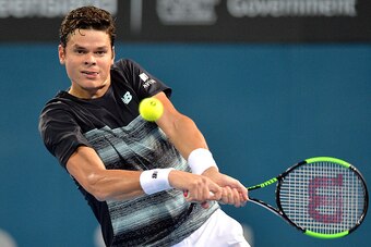 BRISBANE, AUSTRALIA - JANUARY 06:  Milos Raonic of Canada plays a backhand against Rafael Nadal of Spain on day six of the 2017 Brisbane International at Pat Rafter Arena on January 6, 2017 in Brisbane, Australia.  (Photo by Bradley Kanaris/Getty Images)