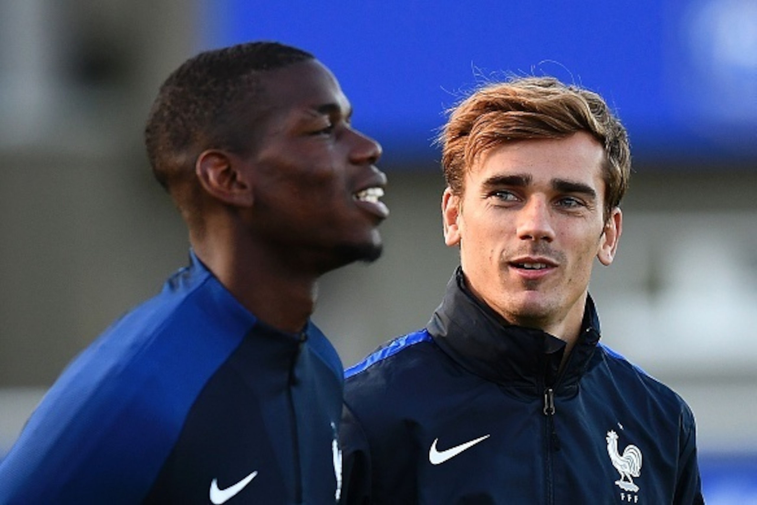 France's forward Antoine Griezmann (R) speaks to France's midfielder Paul Pogba during a training session in Clairefontaine-en-Yvelines near Paris on October 4, 2016 ahead of the 2018 FIFA World Cup football matches against Bulgaria on October 7 and the N