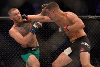 LAS VEGAS, NV - AUGUST 20:   (R-L) Nate Diaz punches Conor McGregor  in their welterweight bout during the UFC 202 event at T-Mobile Arena on August 20, 2016 in Las Vegas, Nevada. (Photo by Brandon Magnus/Zuffa LLC/Zuffa LLC via Getty Images)