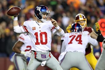 LANDOVER, MD - JANUARY 01: Quarterback Eli Manning #10 of the New York Giants passes the ball while teammate offensive tackle Ereck Flowers #74 blocks against the Washington Redskins in the fourth quarter at FedExField on January 1, 2017 in Landover, Mary