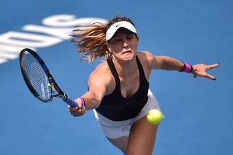 Eugenie Bouchard of Canada hits a return to Shuai Zhang of China in their women's first round match at the Sydney International tennis tournament in Sydney on January 8, 2017. / AFP / PETER PARKS / IMAGE RESTRICTED TO EDITORIAL USE - STRICTLY NO COMMERCIA