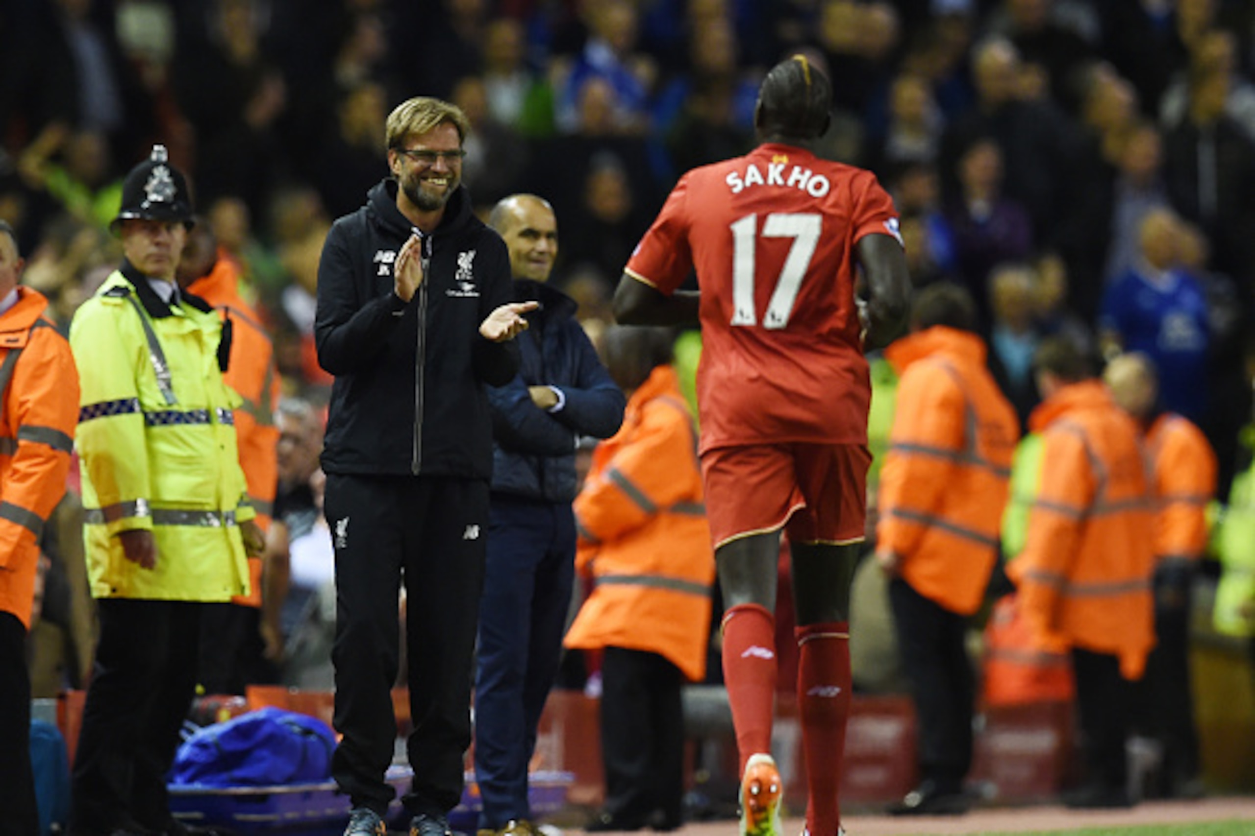 Liverpool's French defender Mamadou Sakho (R) celebrates with Liverpool's German manager Jurgen Klopp after scoring during the English Premier League football match between Liverpool and Everton at Anfield in Liverpool, north west England on April 20, 201
