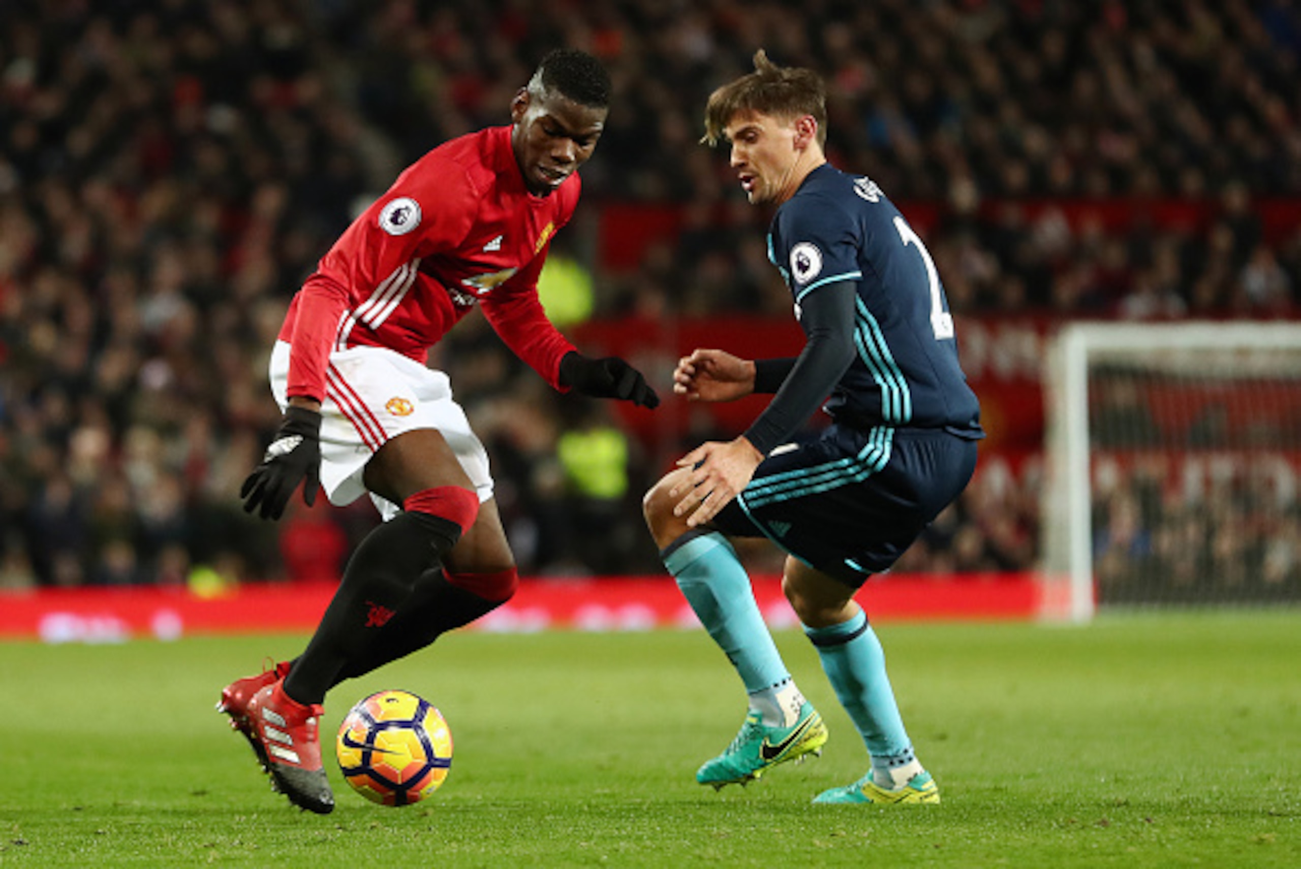 MANCHESTER, ENGLAND - DECEMBER 31: Paul Pogba of Manchester United and Gaston Ramirez of Middlesbrough during the Premier League match between Manchester United and Middlesbrough at Old Trafford on December 31, 2016 in Manchester, England. (Photo by James