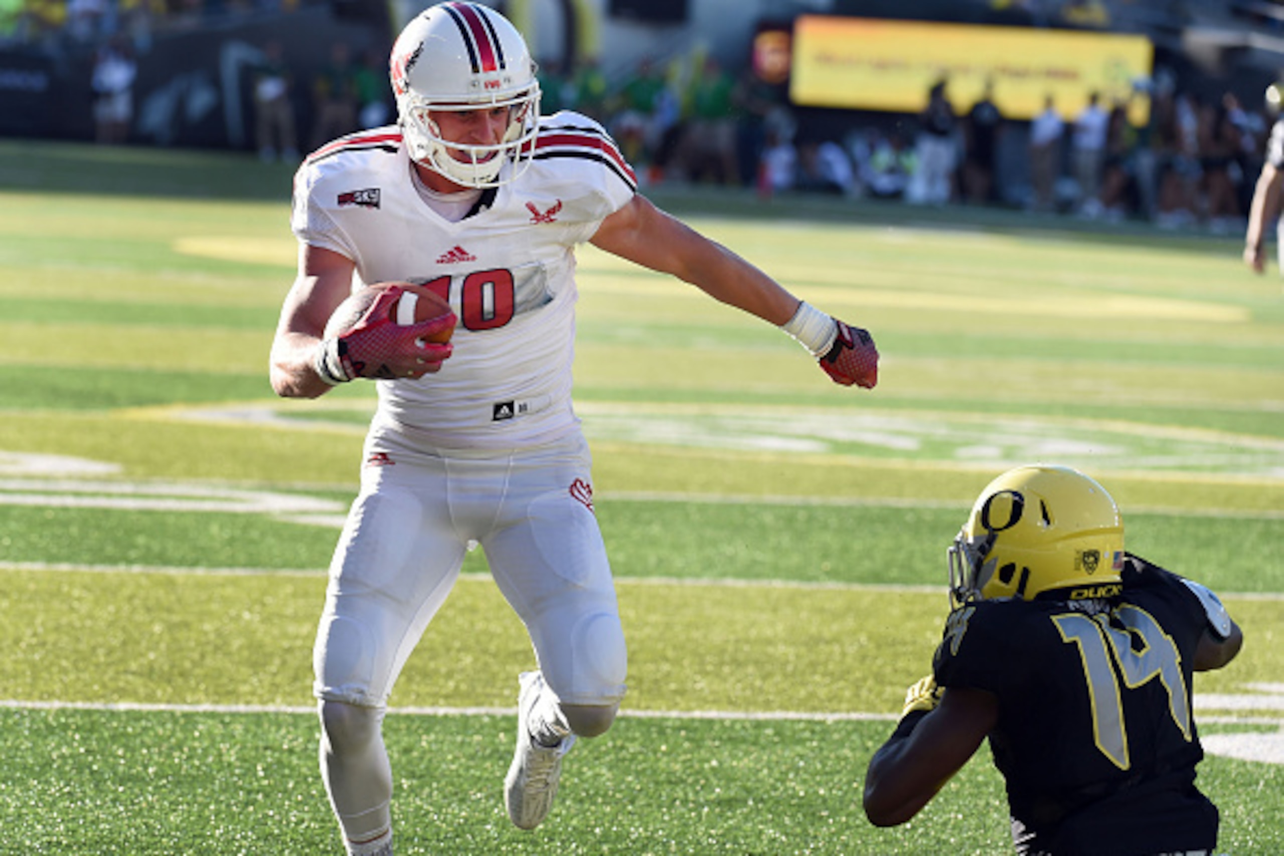 EUGENE, OR - SEPTEMBER 05:  Wide receiver Cooper Kupp #10 of the Eastern Washington Eagles stiff arms cornerback Ugo Amadi #14 of the Oregon Ducks on the way to  touchdown during the second quarter of the game against the Oregon Ducks at Autzen Stadium on