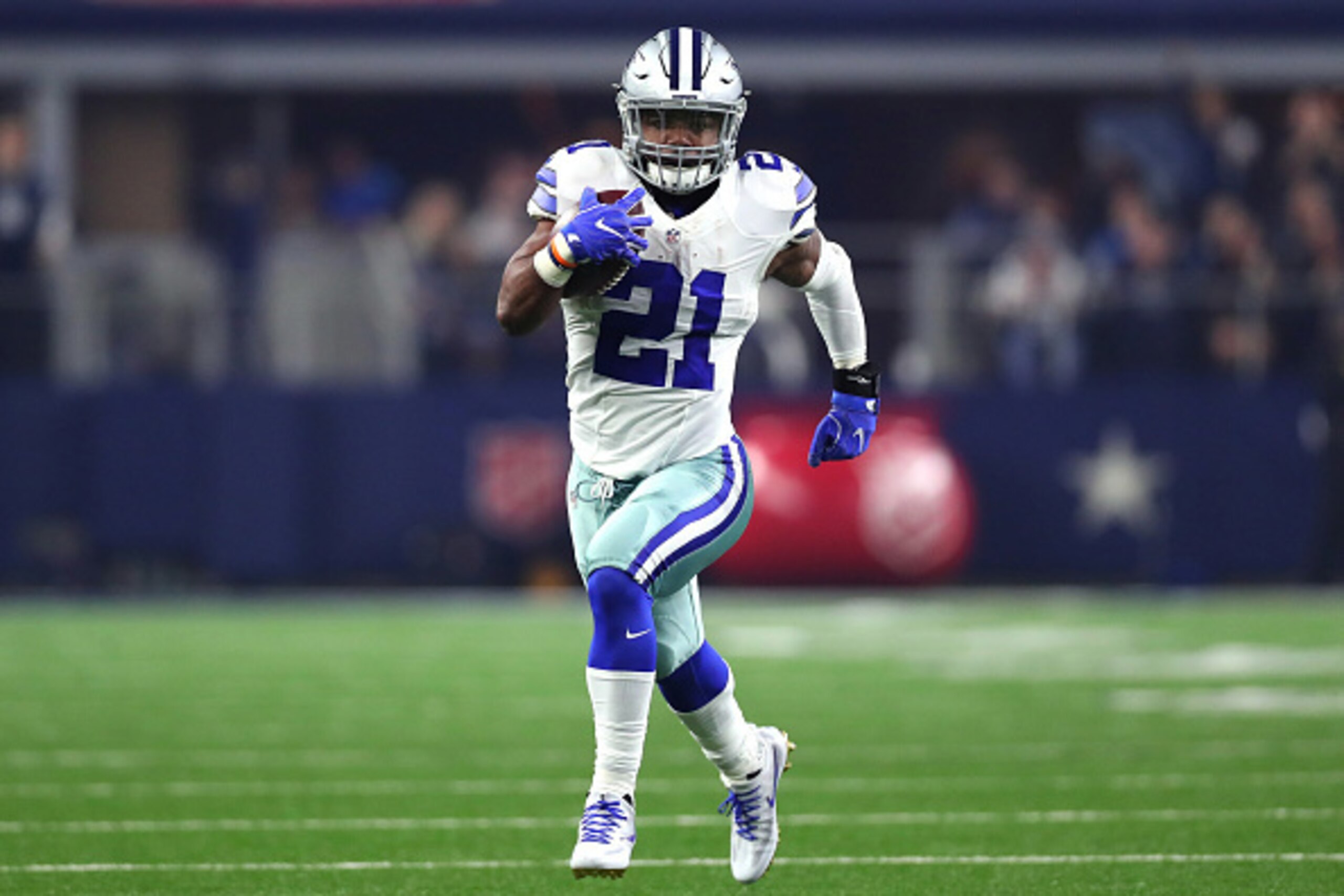ARLINGTON, TX - DECEMBER 26: Ezekiel Elliott #21 of the Dallas Cowboys runs for a touchdown against the Detroit Lions during the first half at AT&T Stadium on December 26, 2016 in Arlington, Texas. (Photo by Tom Pennington/Getty Images)