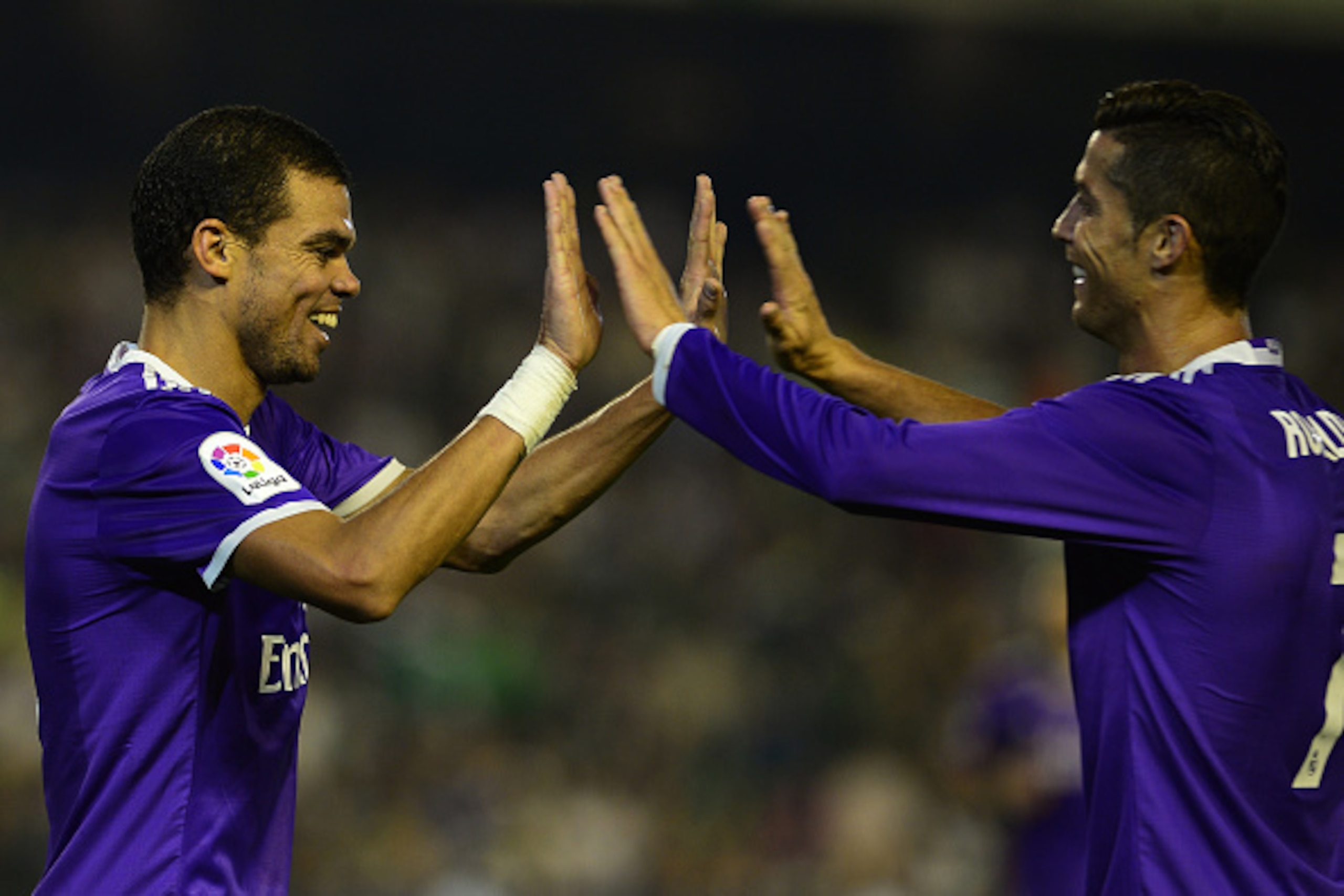 Real Madrid's Portuguese forward Cristiano Ronaldo (R) celebrates with Real Madrid's Portuguese defender Pepe after Real Madrid's midfielder Isco scored during the Spanish league football match Real Betis vs Real Madrid CF at the Benito Villamarin stadium