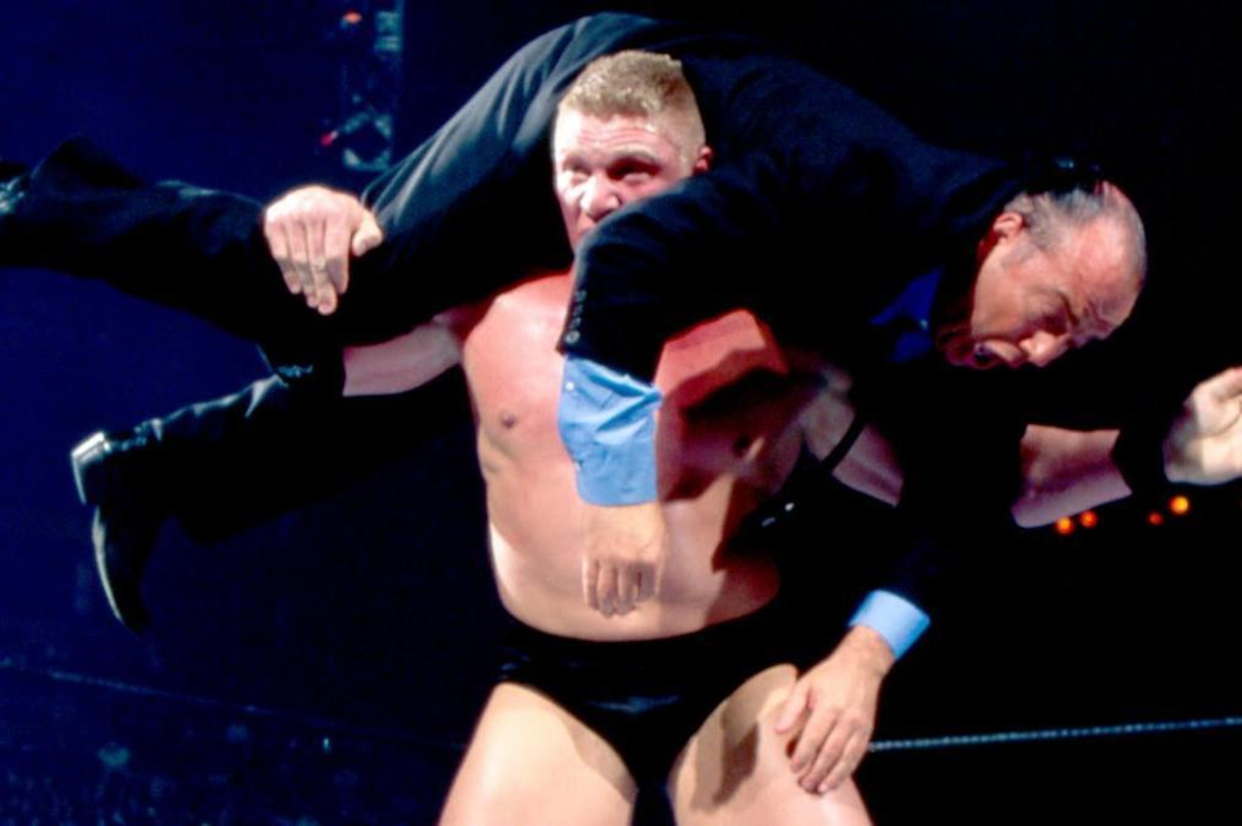 Brock Lesnar sets up Paul Heyman for an F-5. Brock Lesnar sets up Paul Heyman for an F-5.