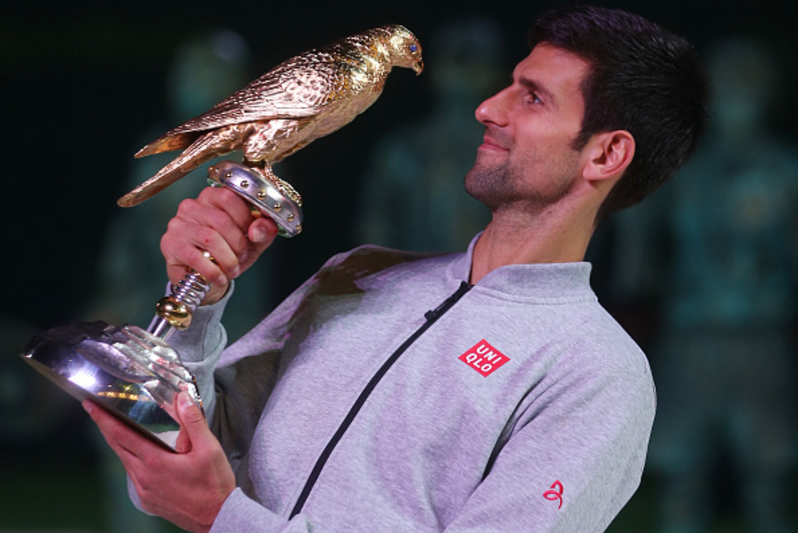 DOHA, QATAR - JANUARY 7: Novak Djokovic of  Serbia  celebrates with the trophy after winning the men's singles final of the  ATP Qatar Open tennis competition against  Andy Murray of Great Britain held at the Khalifa International Tennis Complex on Januar