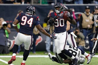 HOUSTON, TX - JANUARY 07:  Jadeveon Clowney #90 of the Houston Texans tips and intercepts a pass from Connor Cook #8 of the Oakland Raiders during the first quarter of their AFC Wild Card game at NRG Stadium on January 7, 2017 in Houston, Texas.  (Photo b