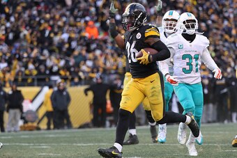PITTSBURGH, PA - JANUARY 08:  Le'Veon Bell #26 of the Pittsburgh Steelers carries the ball into the end zone for a touchdown during the third quarter against the Miami Dolphins in the AFC Wild Card game at Heinz Field on January 8, 2017 in Pittsburgh, Pen