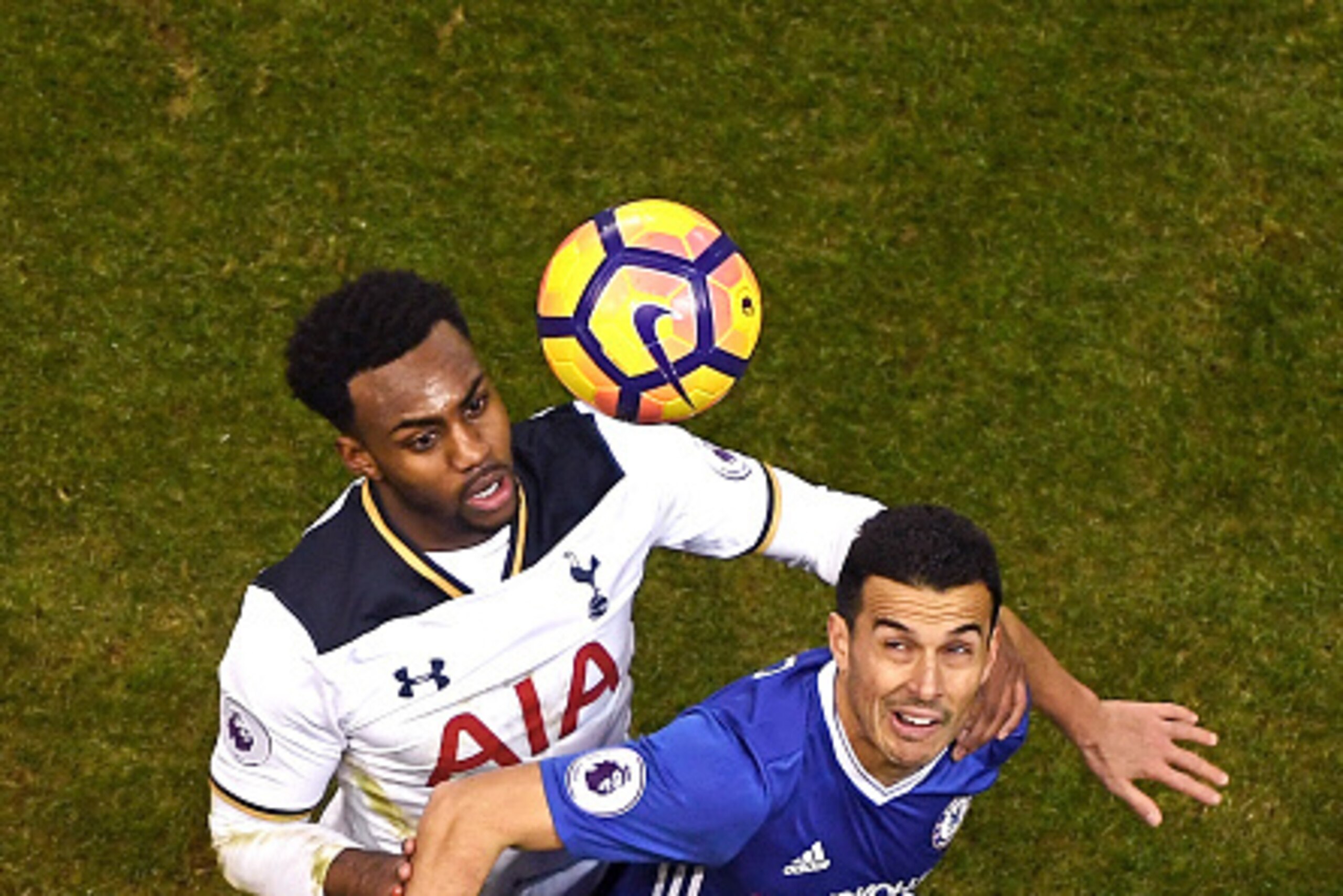 LONDON, ENGLAND - JANUARY 04: (EDITORS NOTE: Retransmission of image 630971302.) Danny Rose of Tottenham Hotspur (L) and Pedro of Chelsea (R) battle to win a header during the Premier League match between Tottenham Hotspur and Chelsea at White Hart Lane o