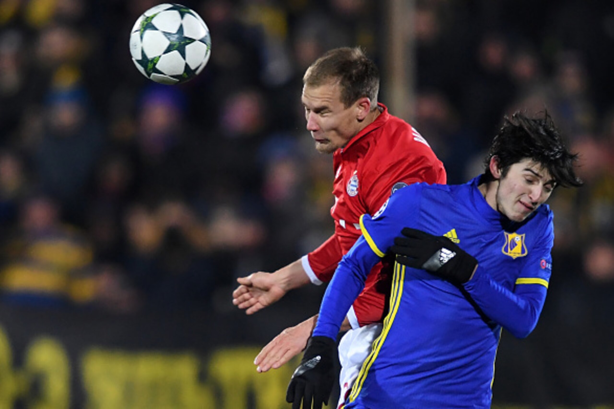 Bayern Munich's defender Holger Badstuber (L) and Rostov's Iranian forward Sardar Azmoun vie for the ball during the UEFA Champions League football match between FC Rostov and FC Bayern Munich at Rostov-on-Don's Olimp 2 stadium on November 23, 2016. / AFP