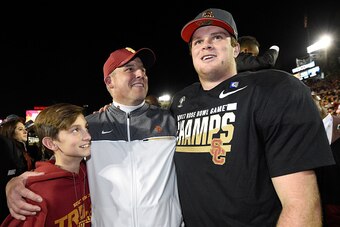 PASADENA, CA - JANUARY 02:  USC Trojans head coach Clay Helton (C) reacts with his son Turner (L) and quarterback Sam Darnold #14 (R) after defeating the Penn State Nittany Lions 52-49 to win the 2017 Rose Bowl Game presented by Northwestern Mutual at the