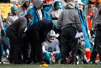 PITTSBURGH, PA - JANUARY 08:  Matt Moore #8 of the Miami Dolphins receives attention on the sideline after taking a hit during the second quarter against the Pittsburgh Steelers in the AFC Wild Card game at Heinz Field on January 8, 2017 in Pittsburgh, Pe