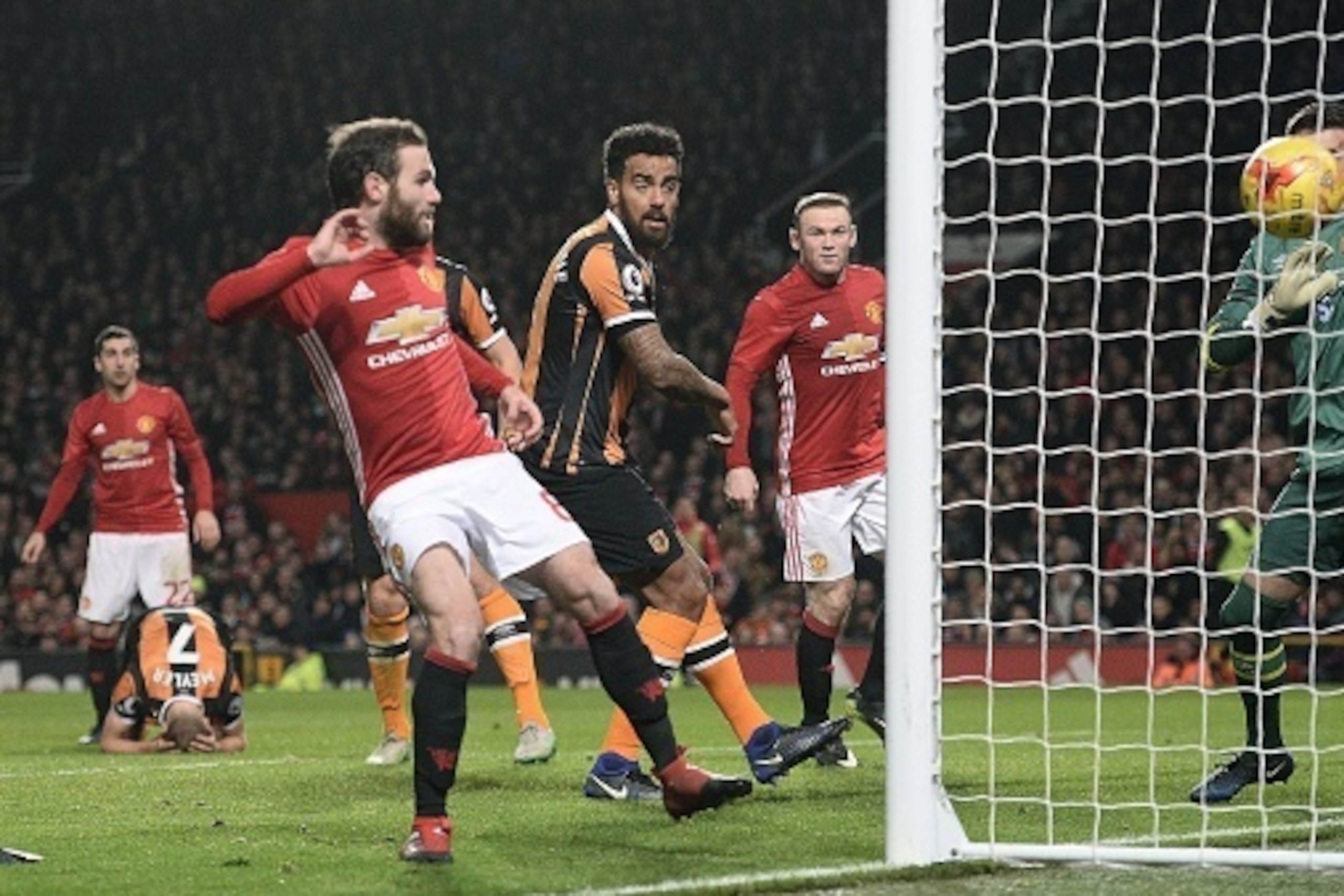 Manchester United's Spanish midfielder Juan Mata (L) scores his team's first goal during the EFL (English Football League) Cup semi-final football match between Manchester United and Hull City at Old Trafford in Manchester, north west England on January 1 Manchester United's Spanish midfielder Juan Mata (L) scores his team's first goal during the EFL (English Football League) Cup semi-final football match between Manchester United and Hull City at Old Trafford in Manchester, north west England on January 1