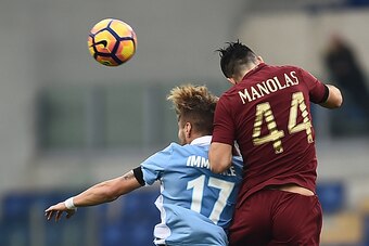 Lazio's forward from Italy Ciro Immobile (L) fights for the ball with Roma's defender from Greece Kostas Manolas during the Italian Serie A football match SS Lazio vs AS Roma on December 4, 2016 at the Olympic stadium in Rome.  / AFP / FILIPPO MONTEFORTE 