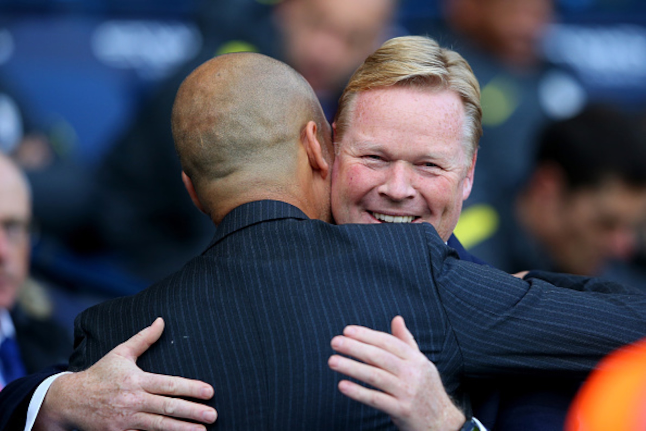 MANCHESTER, ENGLAND - OCTOBER 15:  Josep Guardiola, Manager of Manchester City (L) and Ronald Koeman, Manager of Everton (R) embrace prior to kick off during the Premier League match between Manchester City and Everton at Etihad Stadium on October 15, 201