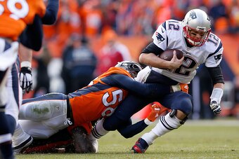 DENVER, CO - JANUARY 24:  Tom Brady #12 of the New England Patriots is sacked by  Von Miller #58 of the Denver Broncos in the second quarter in the AFC Championship game at Sports Authority Field at Mile High on January 24, 2016 in Denver, Colorado.  (Pho