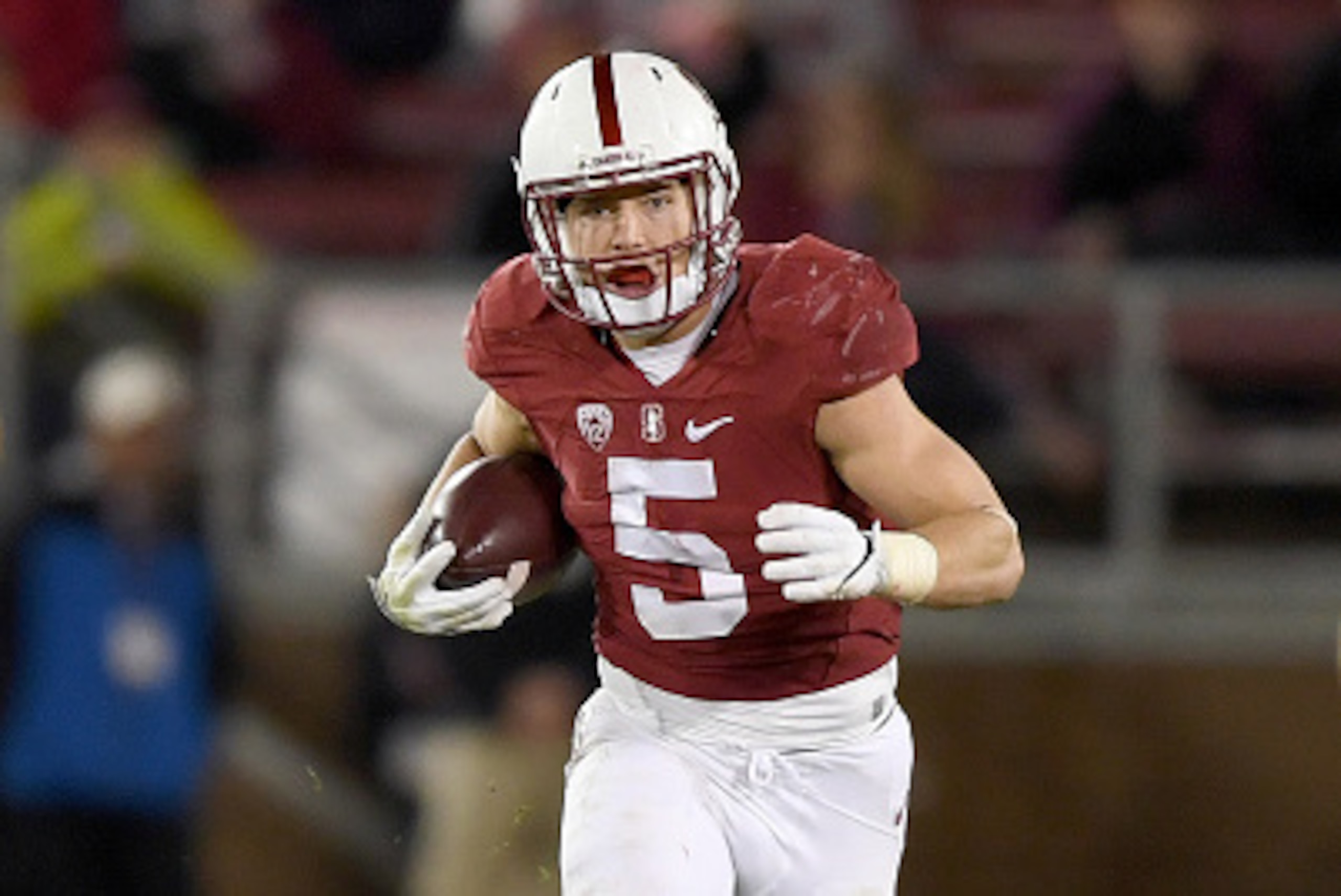 PALO ALTO, CA - NOVEMBER 26:  Christian McCaffrey #5 of the Stanford Cardinal carries the ball against the Rice Owls during the first quarter of their NCAA football game at Stanford Stadium on November 26, 2016 in Palo Alto, California.  (Photo by Thearon