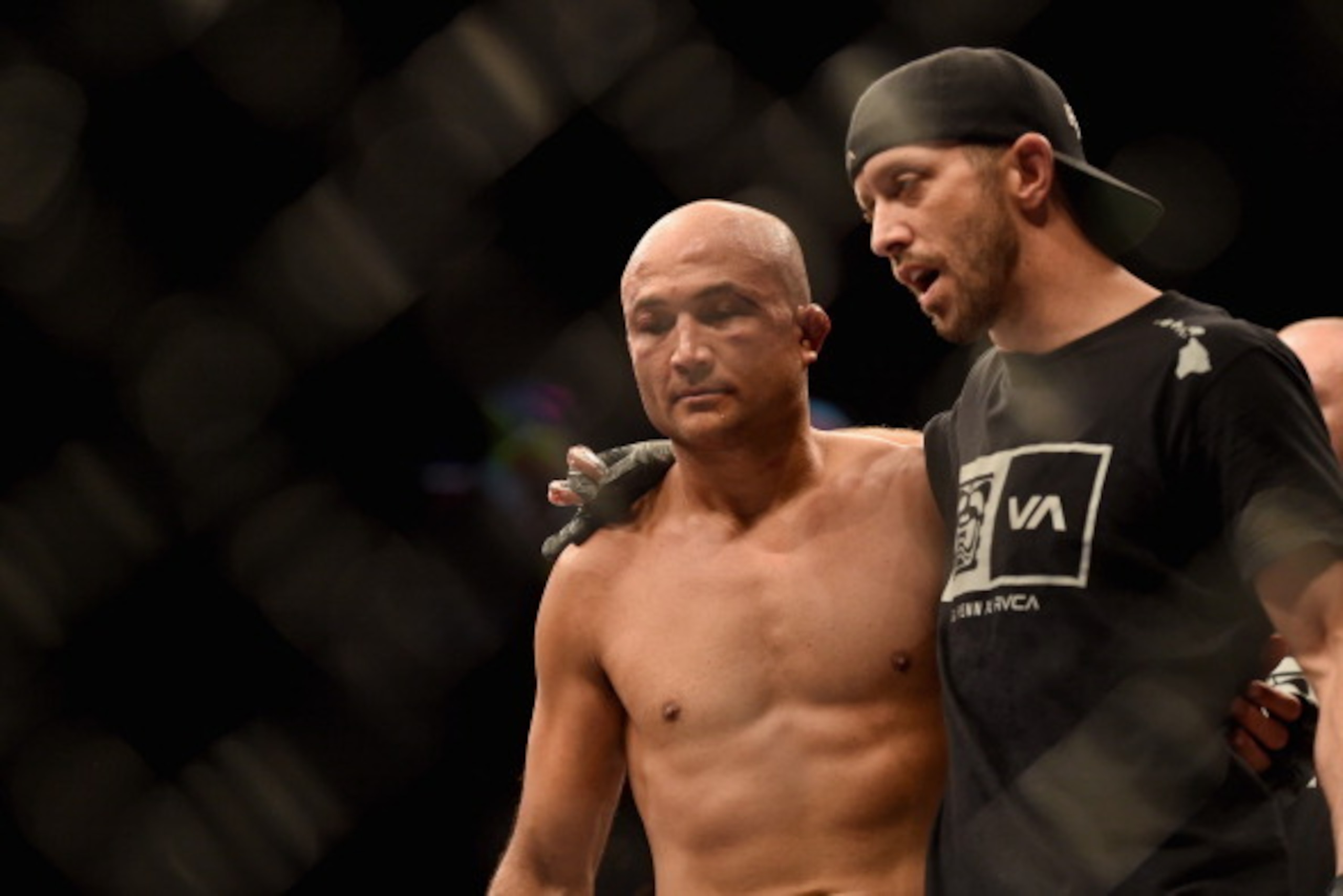 LAS VEGAS, NV - JULY 06:  (L-R) BJ Penn walks out of the Octagon with his boxing coach Jason Parillo after being defeated by Frankie Edgar in their featherweight fight during the Ultimate Fighter Finale inside the Mandalay Bay Events Center on July 6, 201