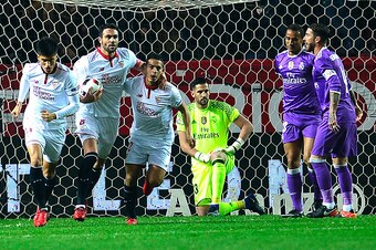Sevilla's players (L) celebrate after Real Madrid's Brazilian defender Danilo (2ndR) scored an own goal during the Spanish Copa del Rey (King's Cup) round of 16 second leg football match Sevilla FC vs Real Madrid CF at the Ramon Sanchez Pizjuan stadium in
