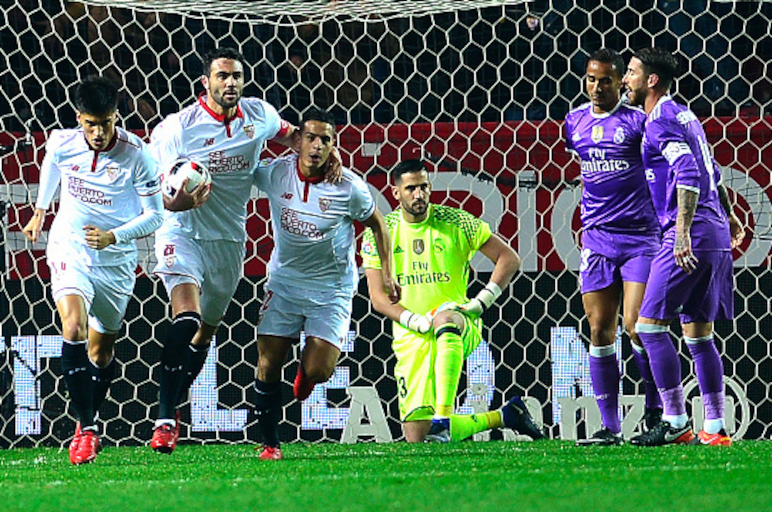 Sevilla's players (L) celebrate after Real Madrid's Brazilian defender Danilo (2ndR) scored an own goal during the Spanish Copa del Rey (King's Cup) round of 16 second leg football match Sevilla FC vs Real Madrid CF at the Ramon Sanchez Pizjuan stadium in