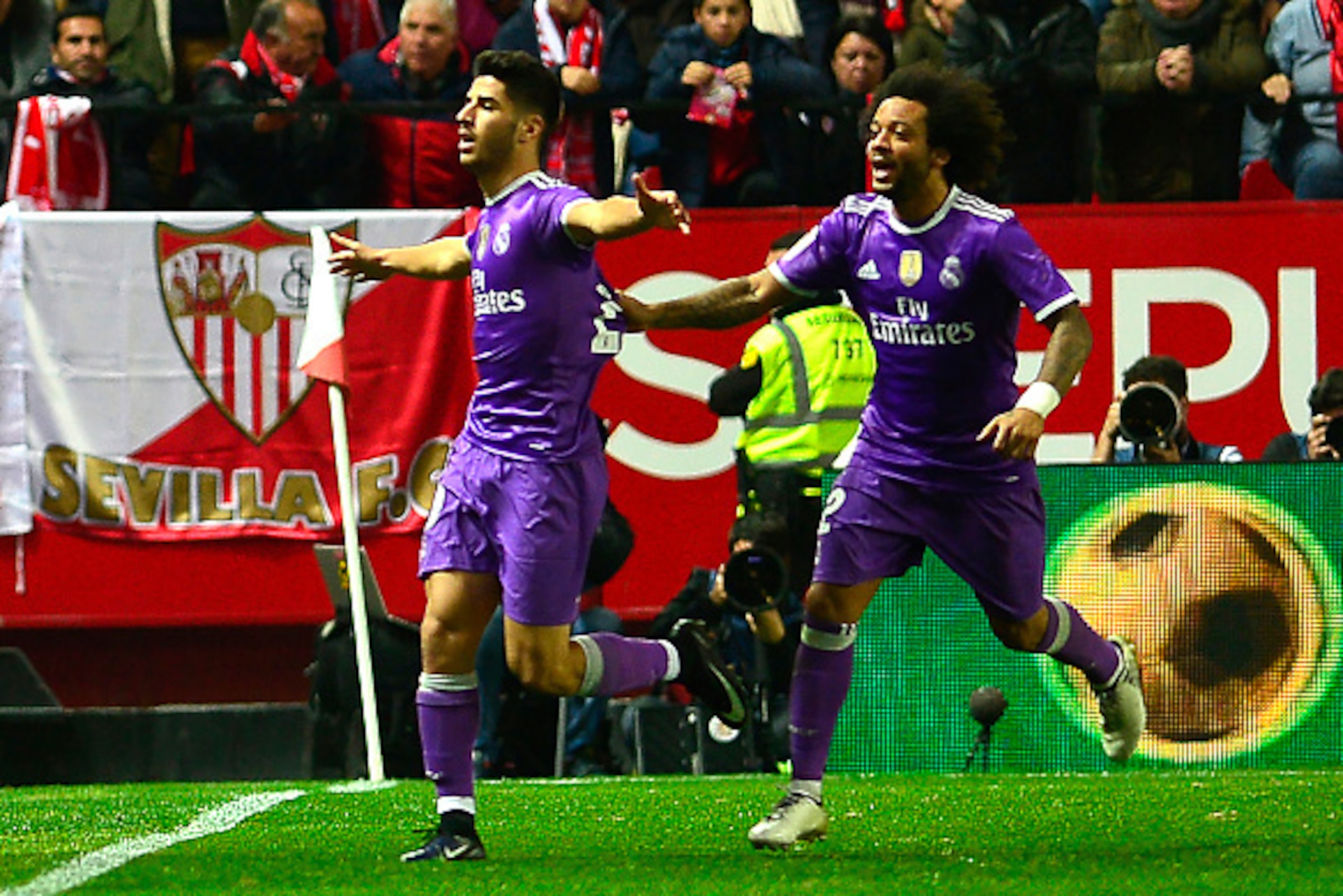 Real Madrid's midfielder Marco Asensio (L) celebrates with Real Madrid's Brazilian defender Marcelo after scoring during the Spanish Copa del Rey (King's Cup) round of 16 second leg football match Sevilla FC vs Real Madrid CF at the Ramon Sanchez Pizjuan 