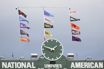 CHICAGO, IL - AUGUST 13: Flags fly above the scoreboard at Wrigley Field during a game between the Chicasgo Cubs and the St. Louis Cardinals on August 13, 2016 in Chicago, Illinois. (Photo by Jonathan Daniel/Getty Images)
