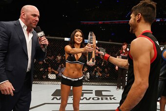 MEXICO CITY, MEXICO - NOVEMBER 15:  Yair Rodriguez (R) is presented his trophy by Dana White (L) and Arianny Celeste (C) after defeating Leonardo Morales in their featherweight bout during the UFC 180 event at Arena Ciudad de Mexico on November 15, 2014 i