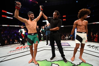 SALT LAKE CITY, UT - AUGUST 06:  (L-R) Yair Rodriguez of Mexico celebrates his victory over Alex Caceres after their featherweight bout during the UFC Fight Night event at Vivint Smart Home Arena on August 6, 2016 in Salt Lake City, Utah. (Photo by Jeff B