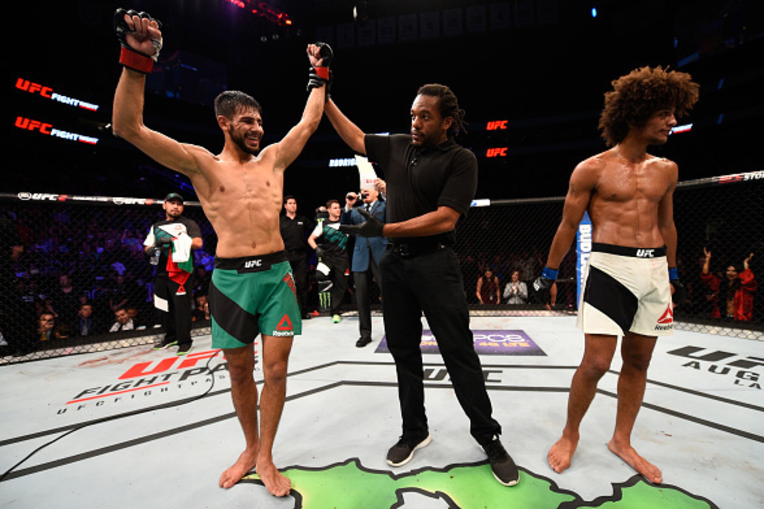 SALT LAKE CITY, UT - AUGUST 06:  (L-R) Yair Rodriguez of Mexico celebrates his victory over Alex Caceres after their featherweight bout during the UFC Fight Night event at Vivint Smart Home Arena on August 6, 2016 in Salt Lake City, Utah. (Photo by Jeff B