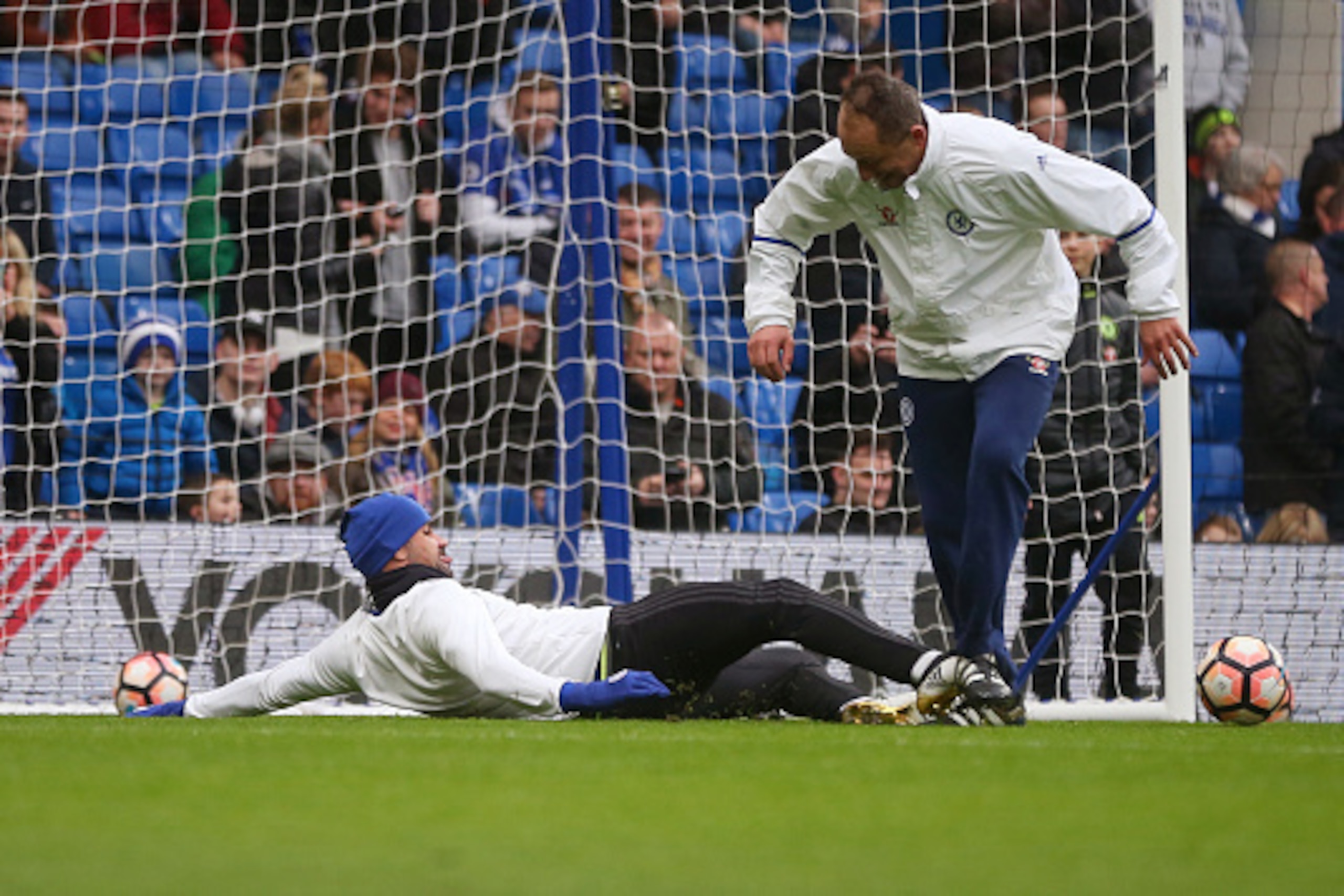 LONDON, ENGLAND - JANUARY 08: Diego Costa of Chelsea tackles goalkeeping coach Gianluca Spinelli as he warms up before the Emirates FA Cup Third Round between Chelsea and Peterborough United at Stamford Bridge on January 8, 2017 in London, England. (Phot LONDON, ENGLAND - JANUARY 08: Diego Costa of Chelsea tackles goalkeeping coach Gianluca Spinelli as he warms up before the Emirates FA Cup Third Round between Chelsea and Peterborough United at Stamford Bridge on January 8, 2017 in London, England. (Phot