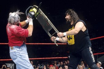 Cactus Jack attacks Chainsaw Charlie with a steel chair to open the 1998 Royal Rumble.