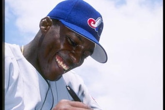 11 May 1997:  Outfielder Vladimir Guerrero of the Montreal Expos signs his autograph on a ball during a game against the Los Angeles Dodgers at Dodger Stadium in Los Angeles, California.  The Expos won the game 6-3. Mandatory Credit: Jose L. Marin  /Allsp