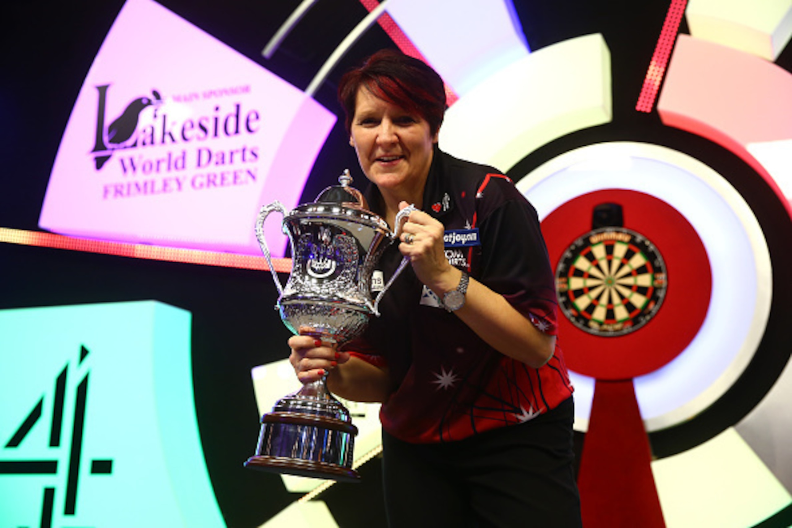 FRIMLEY, ENGLAND - JANUARY 14: Lisa Ashton of England poses with the trophy after victory in her Women's Final match against Corrine Hammond of Australia on Day Eight of the BDO Lakeside World Professional Darts Championships at the Lakeside Country Club FRIMLEY, ENGLAND - JANUARY 14: Lisa Ashton of England poses with the trophy after victory in her Women's Final match against Corrine Hammond of Australia on Day Eight of the BDO Lakeside World Professional Darts Championships at the Lakeside Country Club