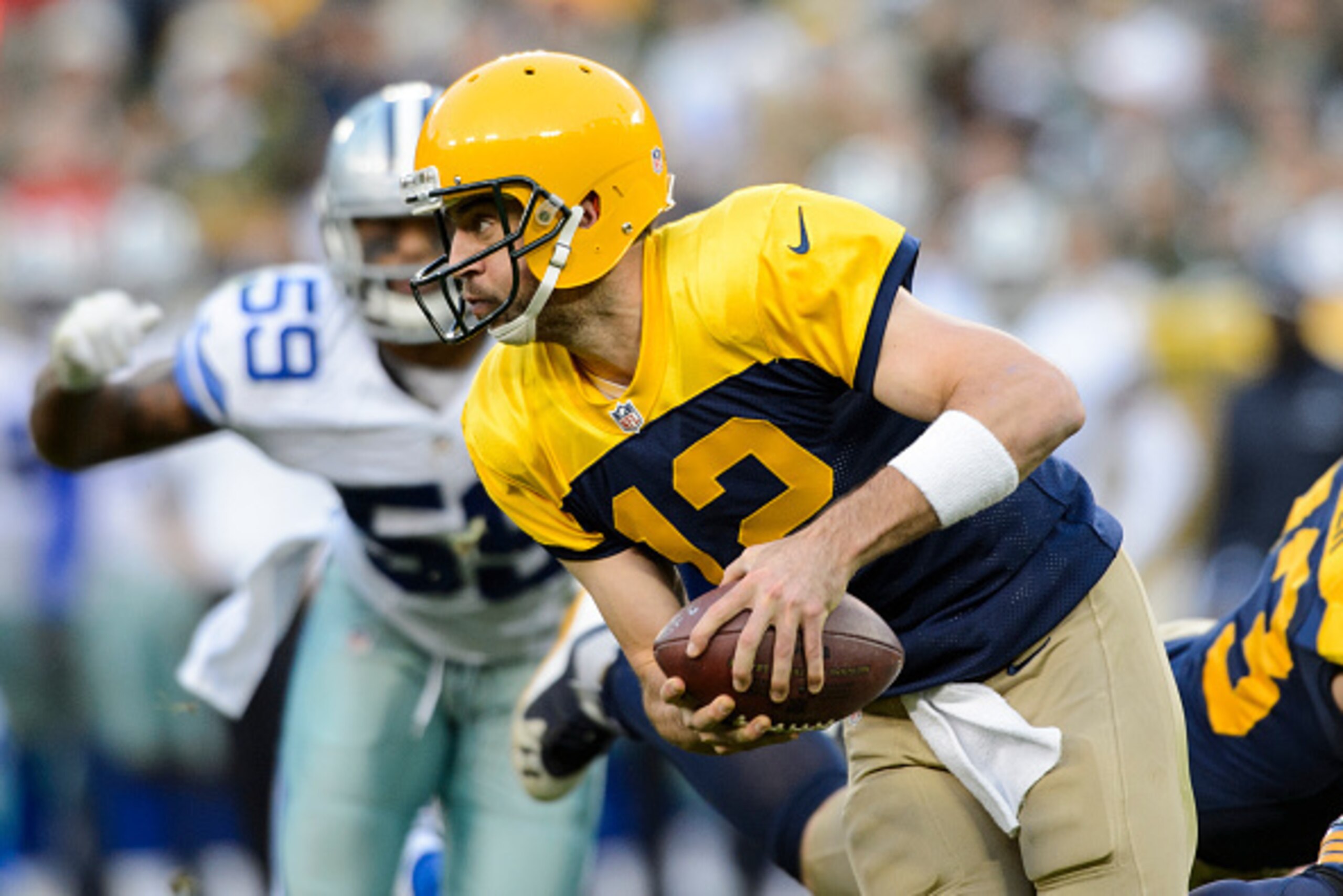 GREEN BAY, WI - OCTOBER 16: Aaron Rodgers #12 of the Green Bay Packers scrambles with the ball against the Dallas Cowboys during the game on October 16, 2016 at Lambeau Field in Green Bay, Wisconsin. The Cowboys defeated the Packers 30-16. (Photo by Hanna