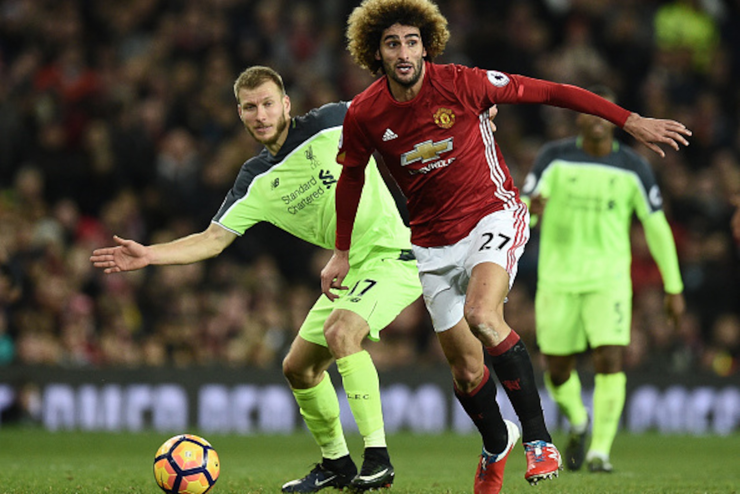 Liverpool's Estonian defender Ragnar Klavan (L) vies with Manchester United's Belgian midfielder Marouane Fellaini during the English Premier League football match between Manchester United and Liverpool at Old Trafford in Manchester, north west England, Liverpool's Estonian defender Ragnar Klavan (L) vies with Manchester United's Belgian midfielder Marouane Fellaini during the English Premier League football match between Manchester United and Liverpool at Old Trafford in Manchester, north west England,