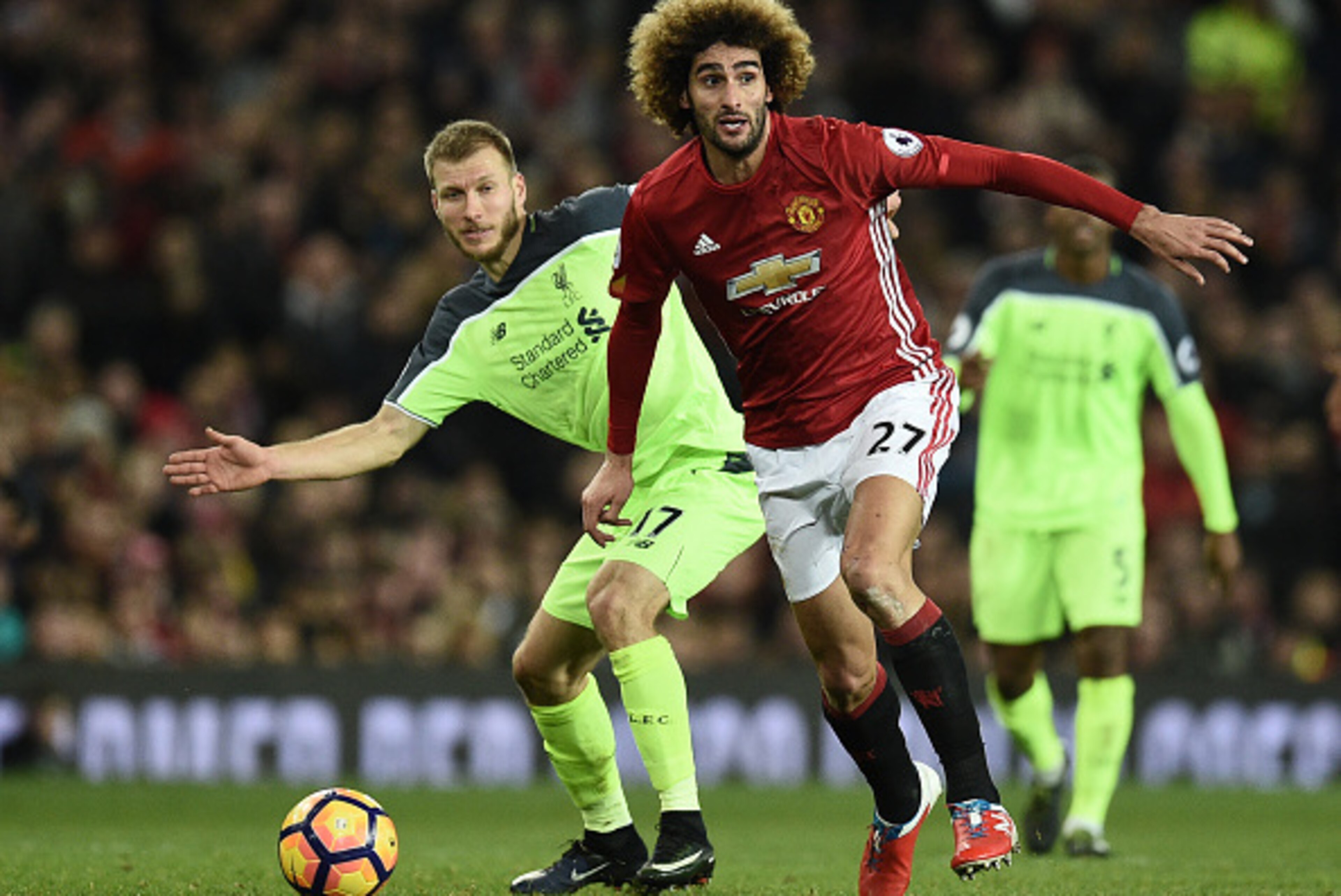 Liverpool's Estonian defender Ragnar Klavan (L) vies with Manchester United's Belgian midfielder Marouane Fellaini during the English Premier League football match between Manchester United and Liverpool at Old Trafford in Manchester, north west England, 