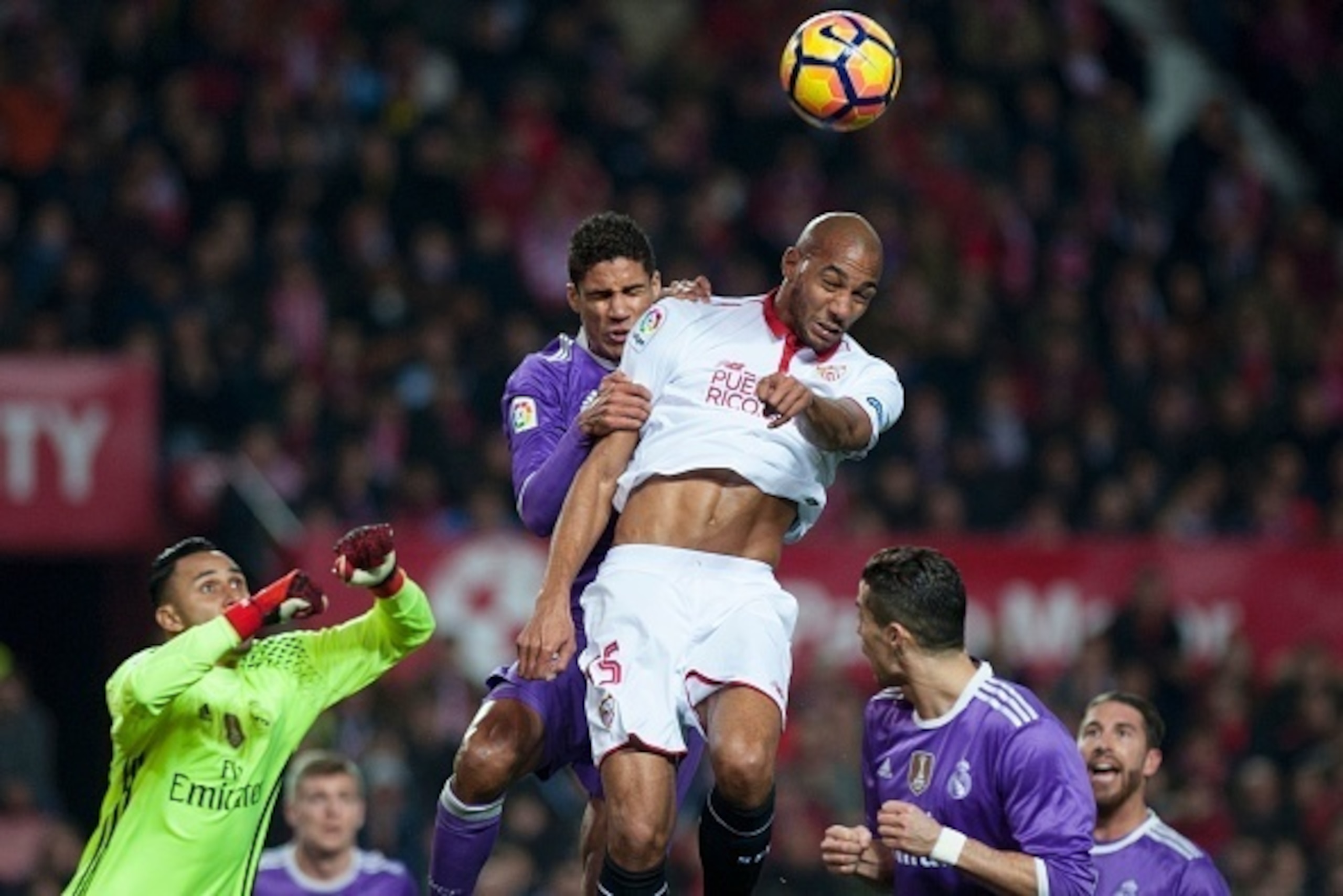 Real Madrid's French defender Raphael Varane (Top L) vies with Sevilla's French midfielder Steven N'Zonzi during the Spanish league football match Sevilla FC vs Real Madrid CF at the Ramon Sanchez Pizjuan stadium in Sevilla on January 15, 2017. / AFP / JO