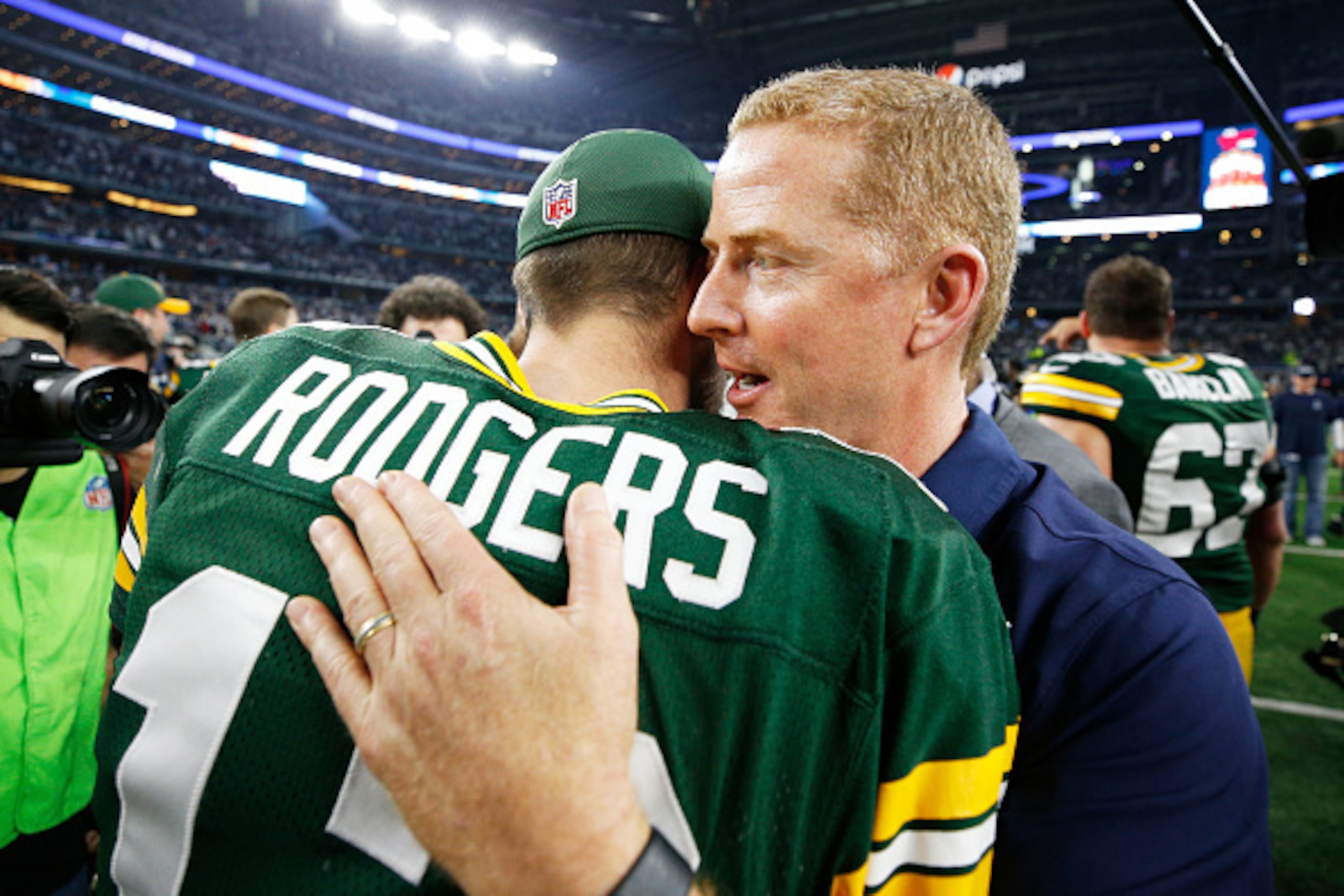 ARLINGTON, TX - JANUARY 15:  Head coach Jason Garrett of the Dallas Cowboys meets with Aaron Rodgers #12 of the Green Bay Packers after the Green Bay Packers beat the Dallas Cowboys 34-31 in the NFC Divisional Playoff Game at AT&T Stadium on January 15, 2