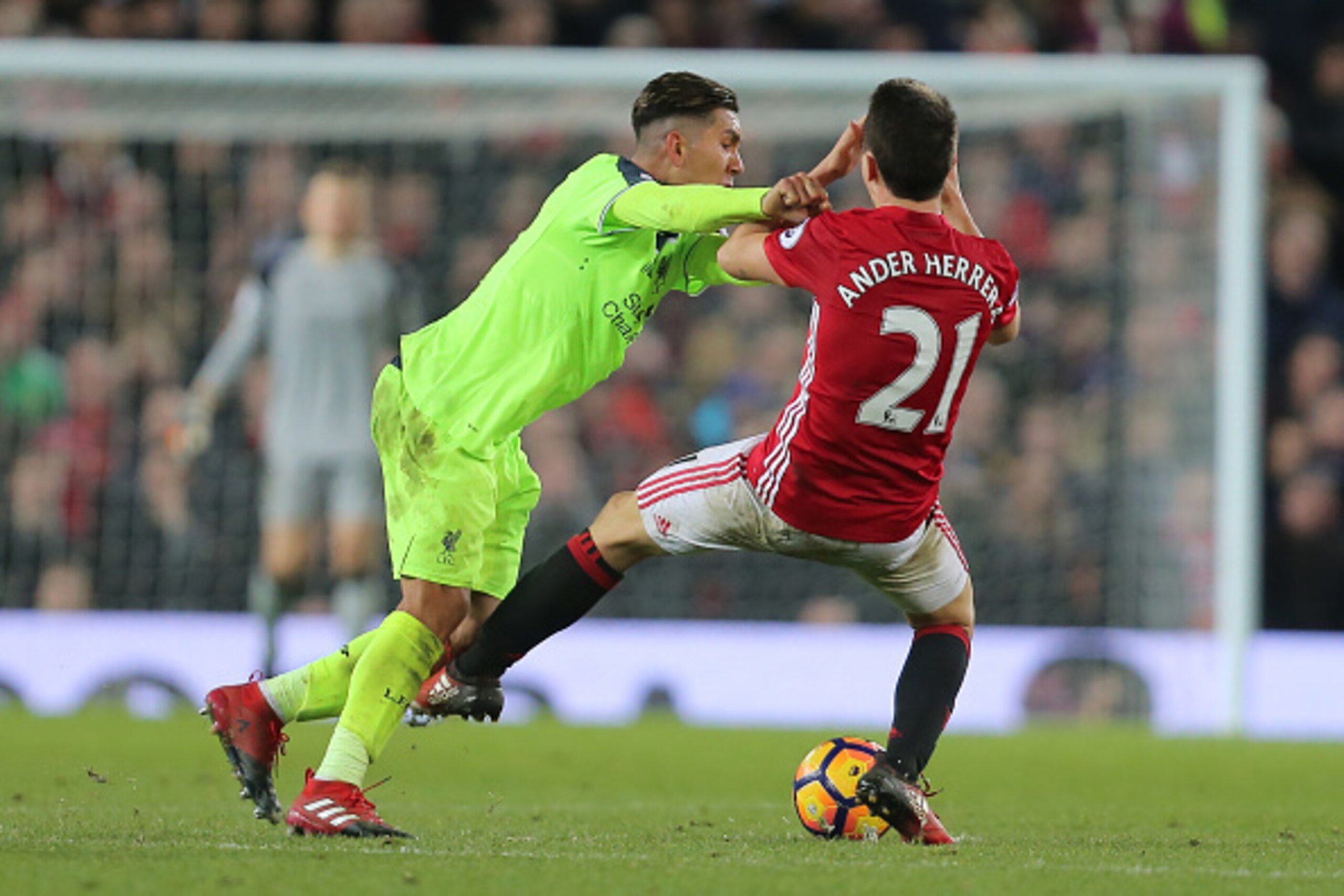 MANCHESTER, ENGLAND - JANUARY 15:  Ander Herrera of Manchester United clashes with Roberto Firminio of Liverpool during the Premier League match between Manchester United and Liverpool at Old Trafford on January 15, 2017 in Manchester, England.  (Photo by