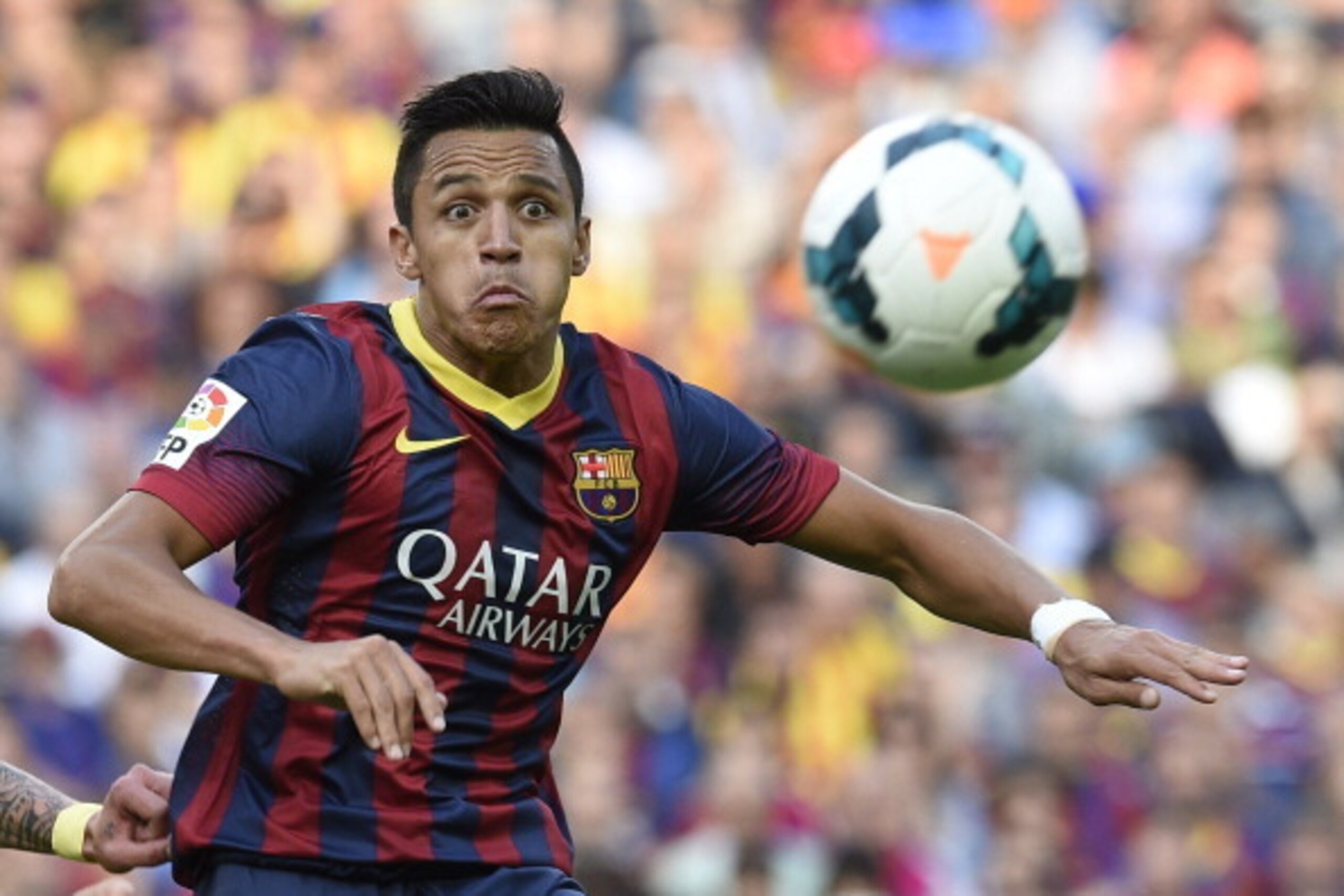 Barcelona's Chilean forward Alexis Sanchez eyes the ball during the Spanish league football match FC Barcelona vs Club Atletico de Madrid  at the Camp Nou stadium in Barcelona on May 17, 2014. Atletico Madrid claimed their 10th Spanish league crown today 