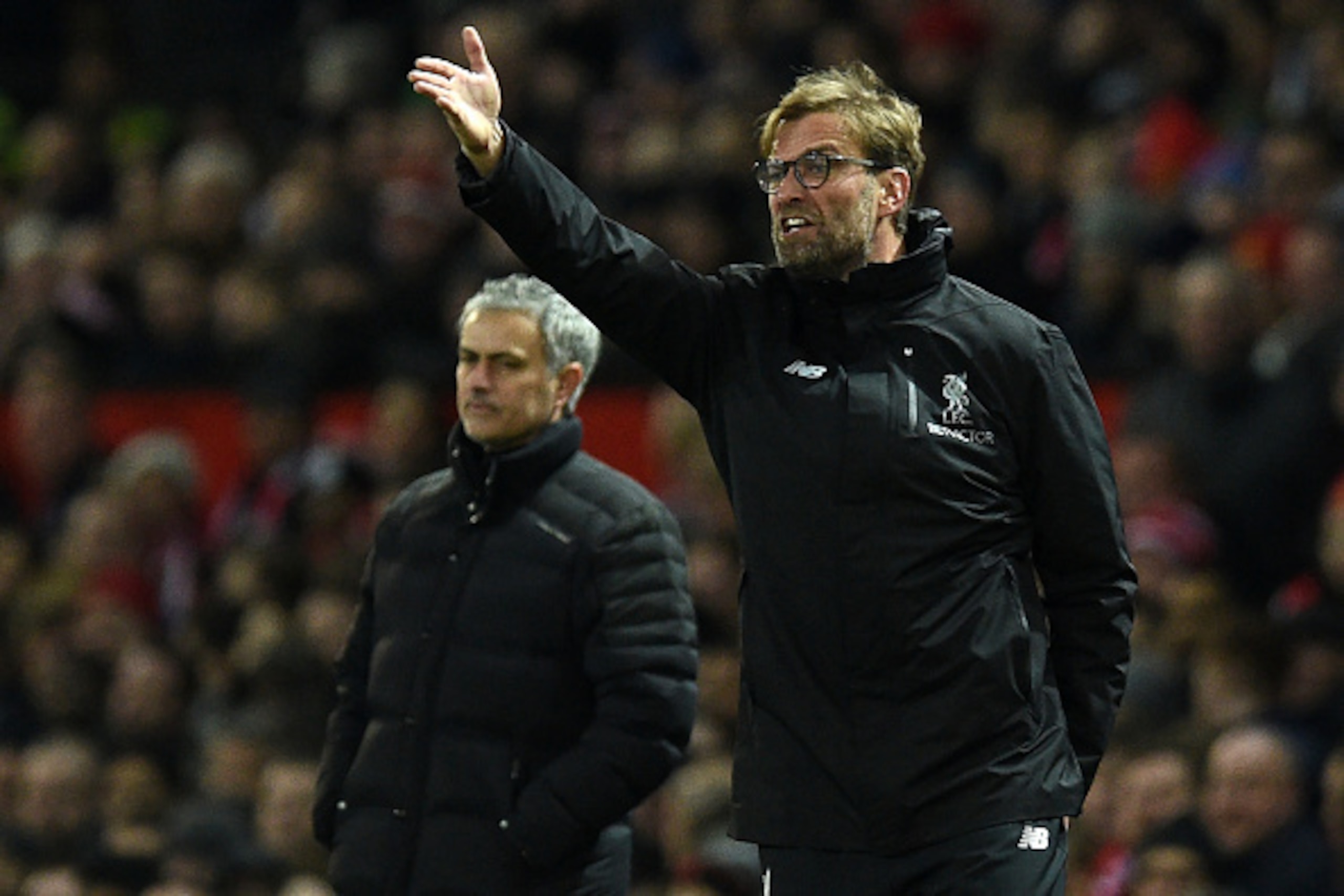Manchester United's Portuguese manager Jose Mourinho (L) looks on as Liverpool's German manager Jurgen Klopp shouts instructions to his players from the touchline during the English Premier League football match between Manchester United and Liverpool at 