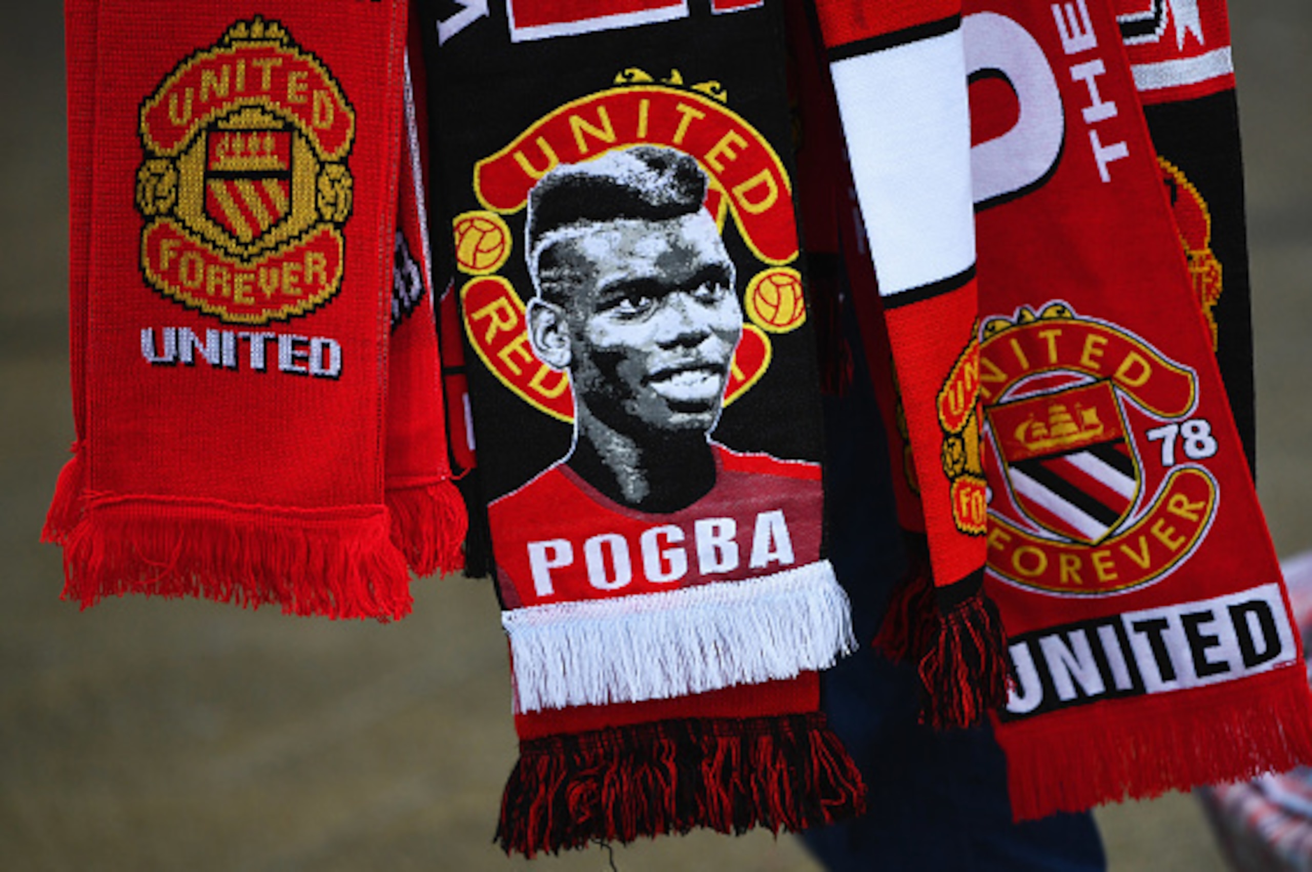 MANCHESTER, ENGLAND - JANUARY 15:  An image of Paul Pogba of Manchester United is seen on a scarf prior to the Premier League match between Manchester United and Liverpool at Old Trafford on January 15, 2017 in Manchester, England.  (Photo by Laurence Gri